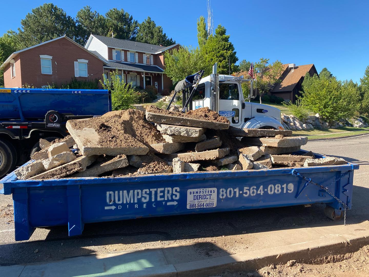 Dumpsters Direct roll off dumpster loaded with broken concrete